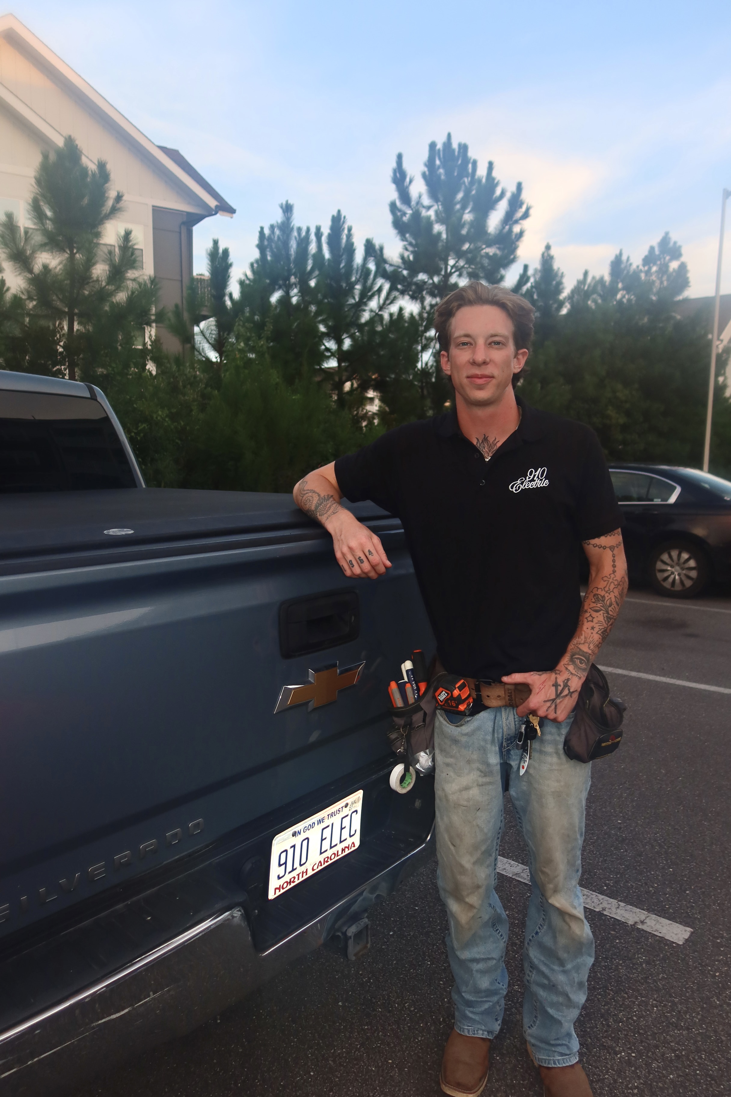 Matt Mydosh, owner of 910 Electric, standing at the tailgate of his Silverado with a 910 ELEC North Carolina plate